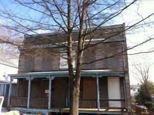 facade of old, boarded up house