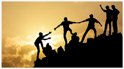 people helping each other climb a mountain